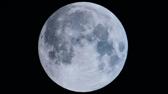 The full Moon glowing against the black of space